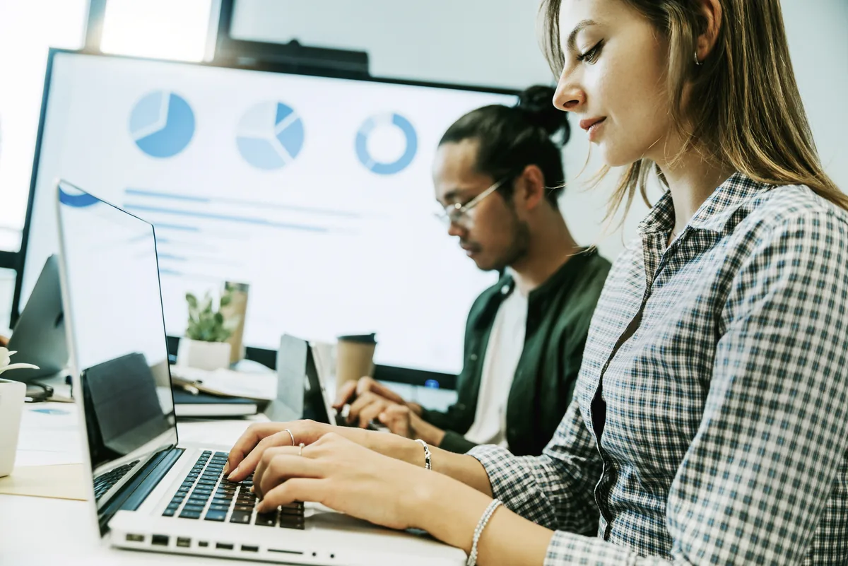 A marketing team reviewing campaign results on a laptop