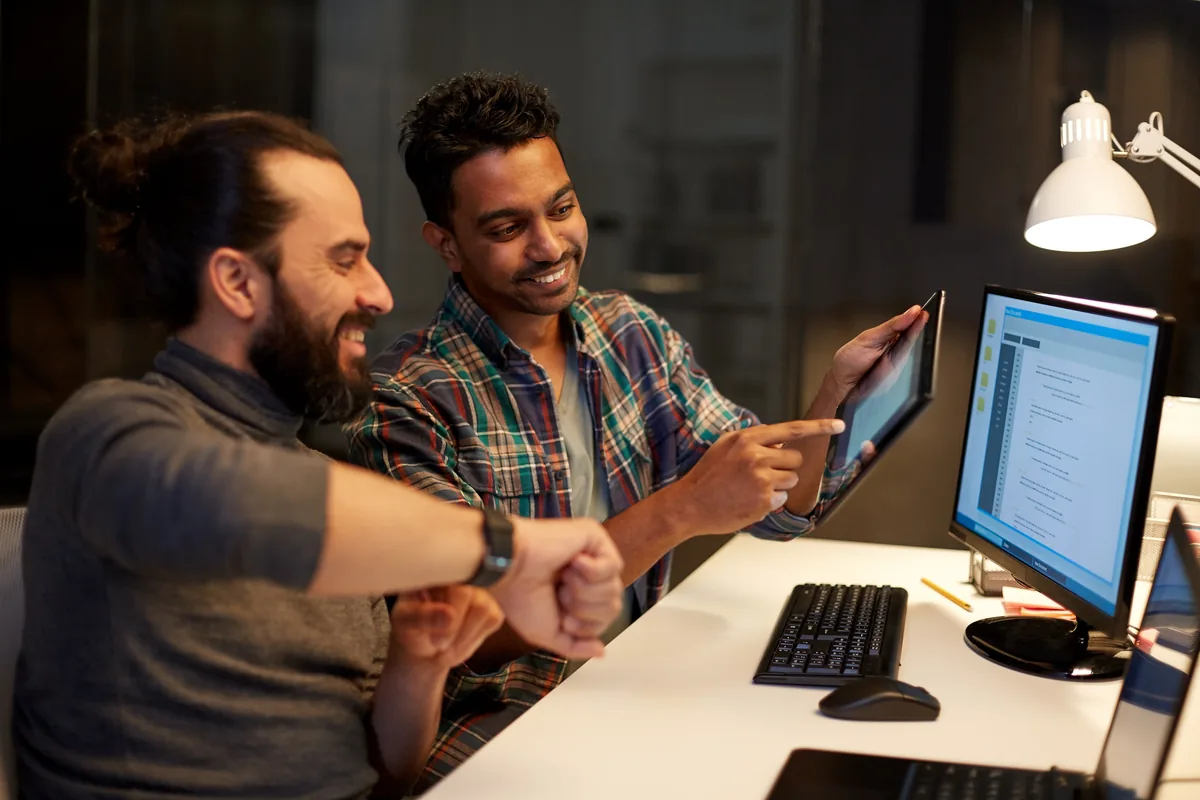 A web design team working together at a shared desk