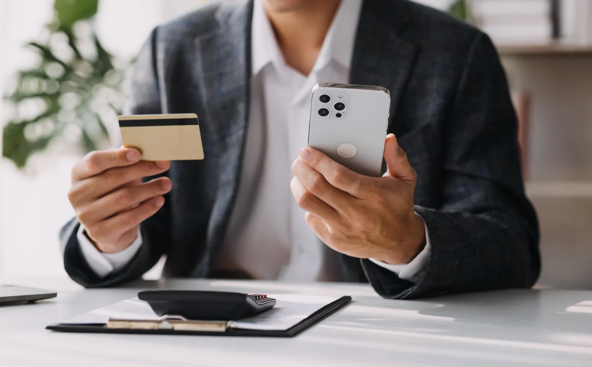 A professional sharing a digital business card on a smartphone